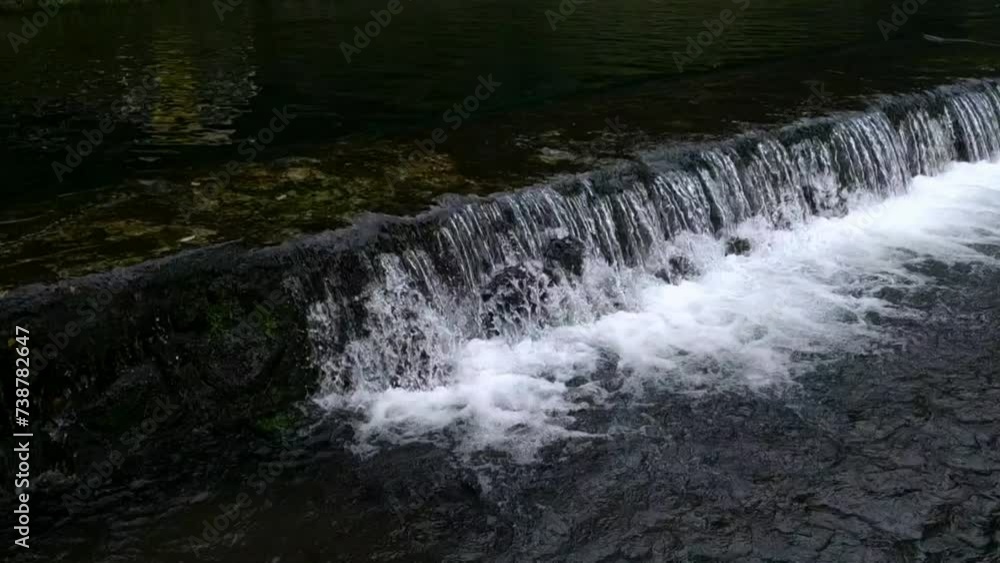 flowing water on the edge of an outdoor pool flowing water on the edge of an outdoor pool
