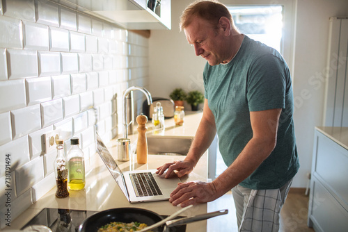 Man preparing meal in the home kitchen photo