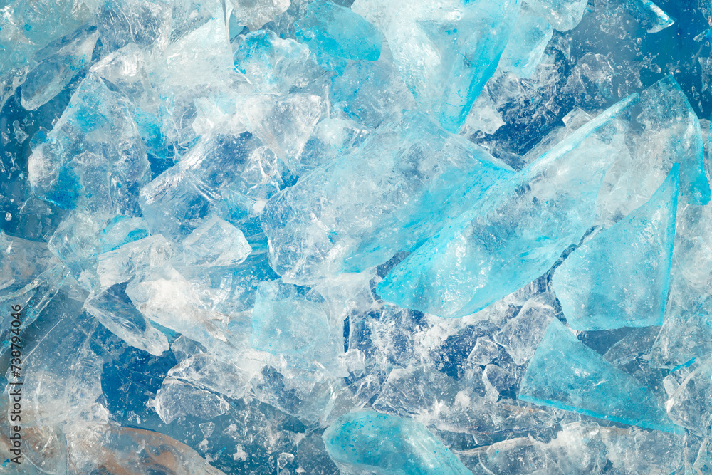 broken ice close up. pieces of crushed blue ice cracks background texture. close-up frozen water. broken ice close up. pieces of crushed blue ice cracks background texture. close-up frozen water.