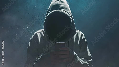 In the realm of cybersecurity, an ominous figure clad in a hoodie embodies the archetype of a computer hacker photo