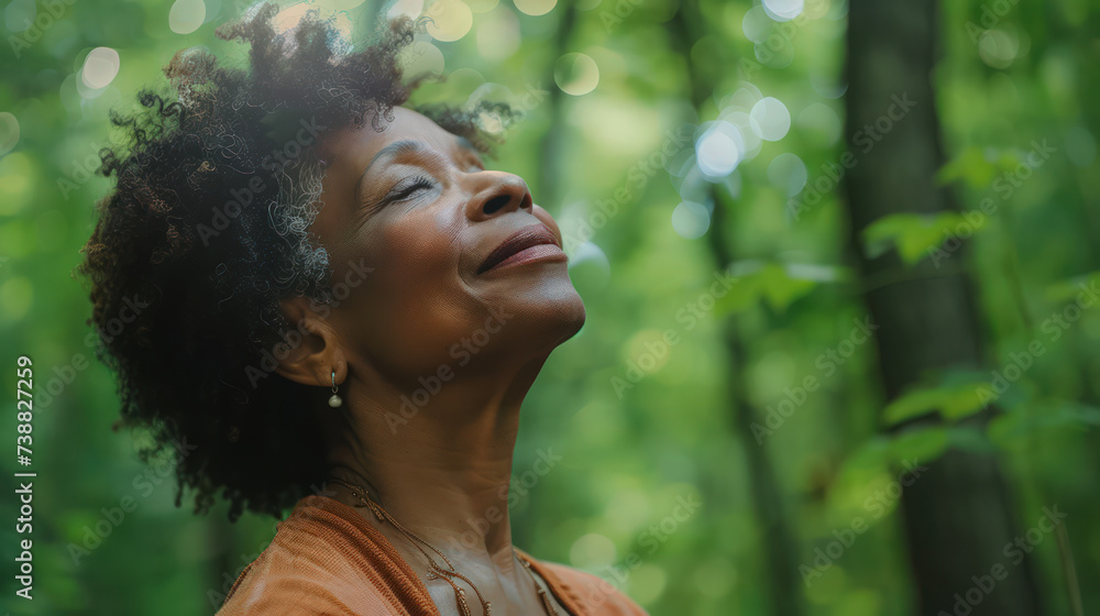 relaxed Mature Black American woman breathing fresh air in a green forest relaxed Mature Black American woman breathing fresh air in a green forest