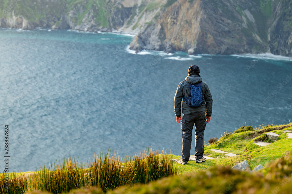 Tourist at Slieve League, Irelands highest sea cliffs, located in south west Donegal along this magnificent costal driving route. One of the most popular stops at Wild Atlantic Way route.