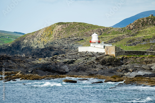 Valentia Island Lighthouse at Cromwell Point. Locations worth visiting on the Wild Atlantic Way. Scenic Irish countyside on sunny summer day, County Kerry, Ireland. photo