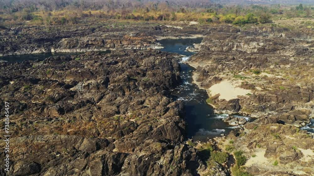 The arid countryside at Li Phi Falls on the Mekong in Asia, Laos, Champasak, 4000 islands, Don Det, on a sunny day. The arid countryside at Li Phi Falls on the Mekong in Asia, Laos, Champasak, 4000 islands, Don Det, on a sunny day.