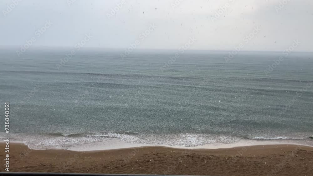 Sea beach thunderstorm with sound, heavy rain on the sea seen from the shore