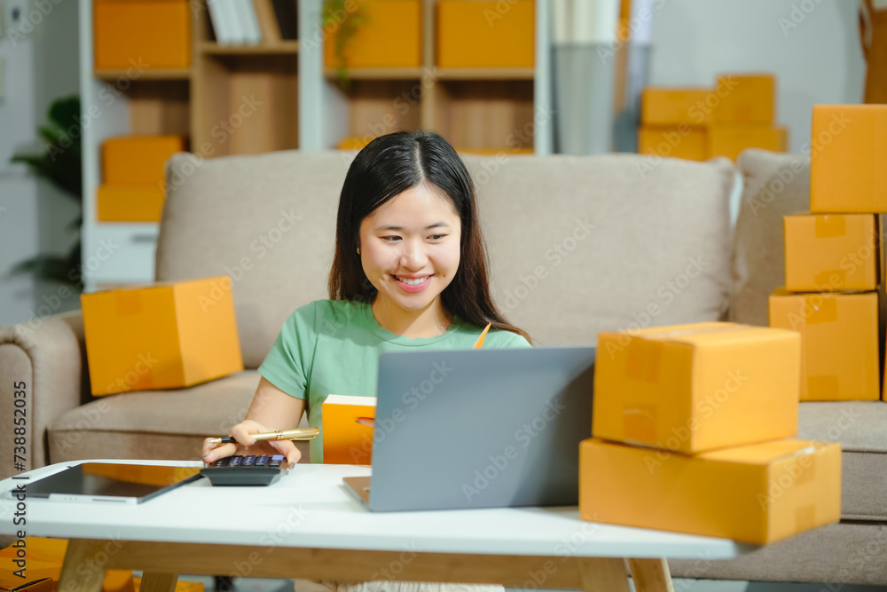 young Asian entrepreneur, the owner of a small clothing store, organizes online live streams showcasing products packaged in cardboard boxes, ensuring prompt and efficient delivery. young Asian entrepreneur, the owner of a small clothing store, organizes online live streams showcasing products packaged in cardboard boxes, ensuring prompt and efficient delivery.