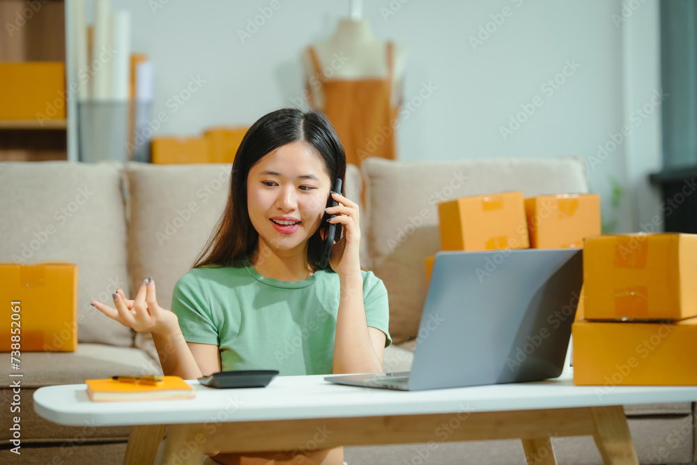 young Asian entrepreneur, the owner of a small clothing store, organizes online live streams showcasing products packaged in cardboard boxes, ensuring prompt and efficient delivery. young Asian entrepreneur, the owner of a small clothing store, organizes online live streams showcasing products packaged in cardboard boxes, ensuring prompt and efficient delivery.
