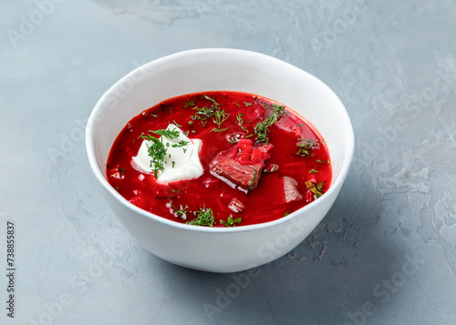 Borscht soup with sour cream in a plate.