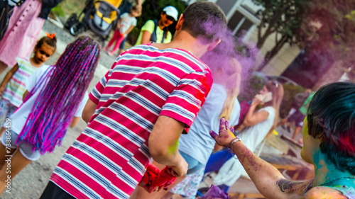 Girl throws colors at guy during Holi festival	
