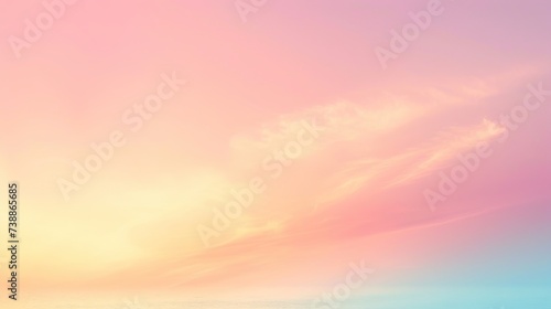Soft pastel hues of pink and yellow blend seamlessly in the sky, with delicate clouds at sunrise.