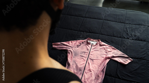 Cyclist man looking at the sportswear that he is going to wear to go out to train on his bicycle in the mountains of Medellin, Colombia photo