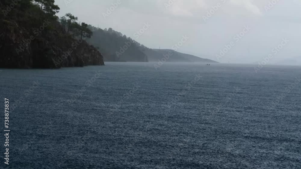 rainy weather at the sea, drops falling into water, heavy rain, stormy day rainy weather at the sea, drops falling into water, heavy rain, stormy day