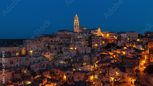 Matera Italy timelapse - old stone houses and caves on a hill at sunset or sunrise. Skyline time lapse of historical village (town) and UNESCO heritage in Europe in the evening (night) or morning.