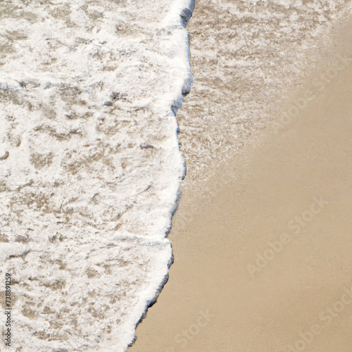 Overhead view of a vertical frothy ocean surf pattern on a wet sandy beach