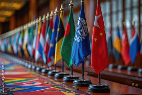 Aligned national flags on elegant stands grace a corridor, signifying the diplomatic exchange and international relations at a high-level conference. photo