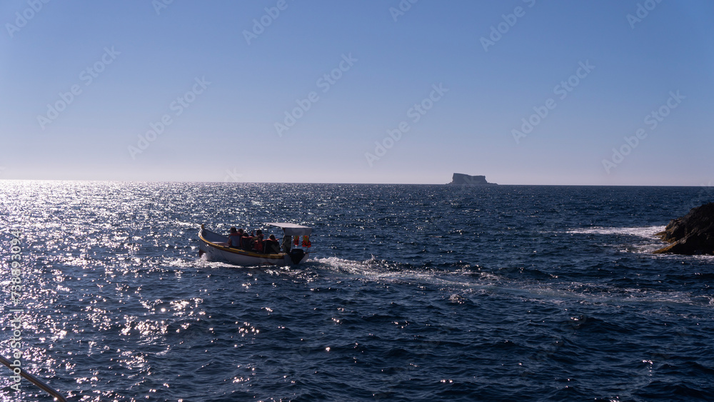 Motor boat rocking on waves in sea water