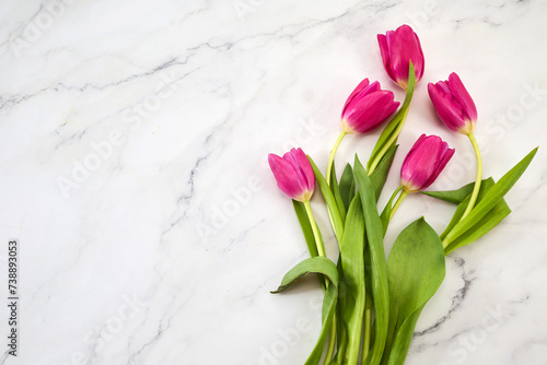 Bouquet of pink tulips on marble background. Mothers day, Valentines Day, Birthday celebration concept.