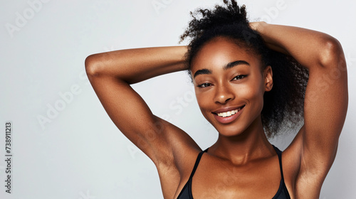 young beautiful sport influencer women showing armpit with smooth clean skin on solid background photo