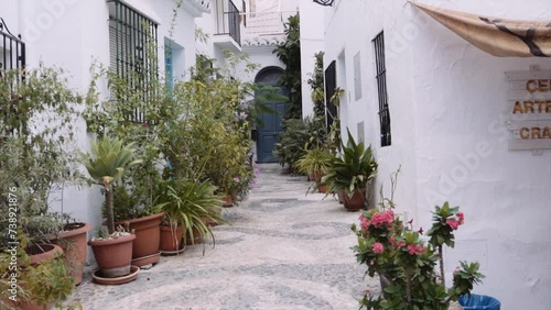 Potted Plants On Narrow Path Leading Towards Closed Door Of House In Frigiliana