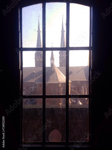 Window in the dark with a Church view and sunny day