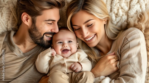 Loving family couple kissing their newborn baby, close up portrait showing pure affection and bond