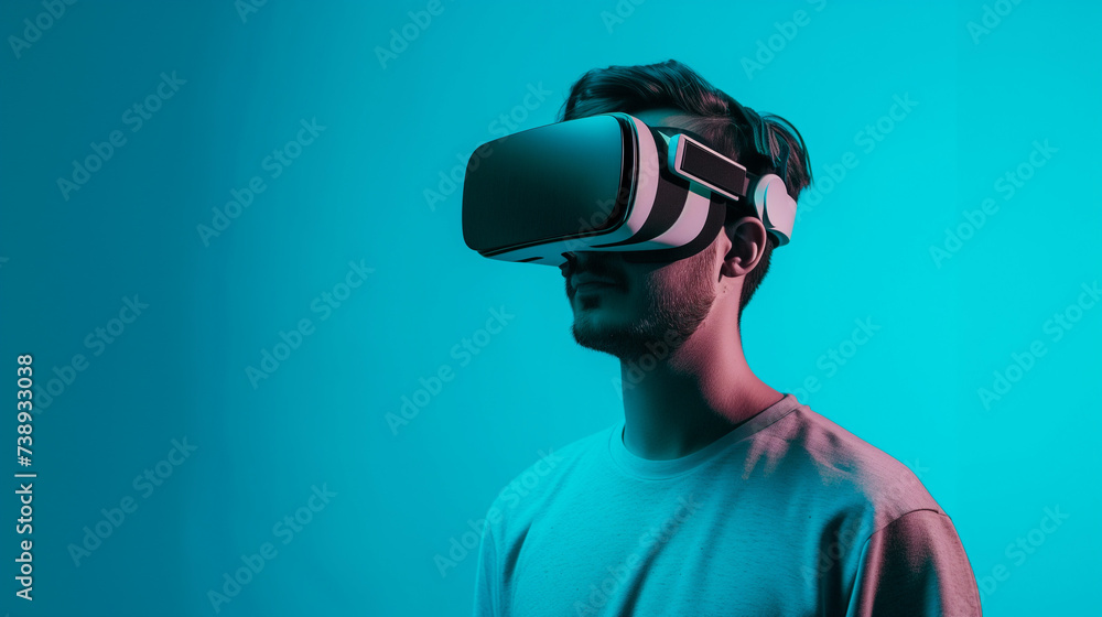 Young Man with VR Headset on Blue Background - Concept of Virtual Reality Experience with Simple Desing and Copy Space Young Man with VR Headset on Blue Background - Concept of Virtual Reality Experience with Simple Desing and Copy Space