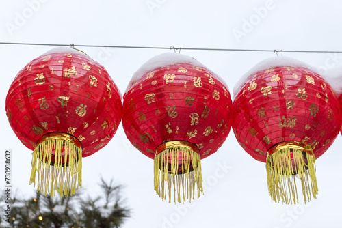 Red lanterns are a traditional decoration for celebrating the New Year according to the Chinese calendar against a gray sky background.