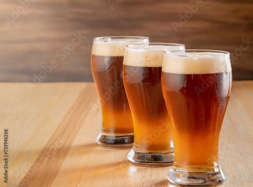 Glasses of beer isolated on wooden background with copy space for design