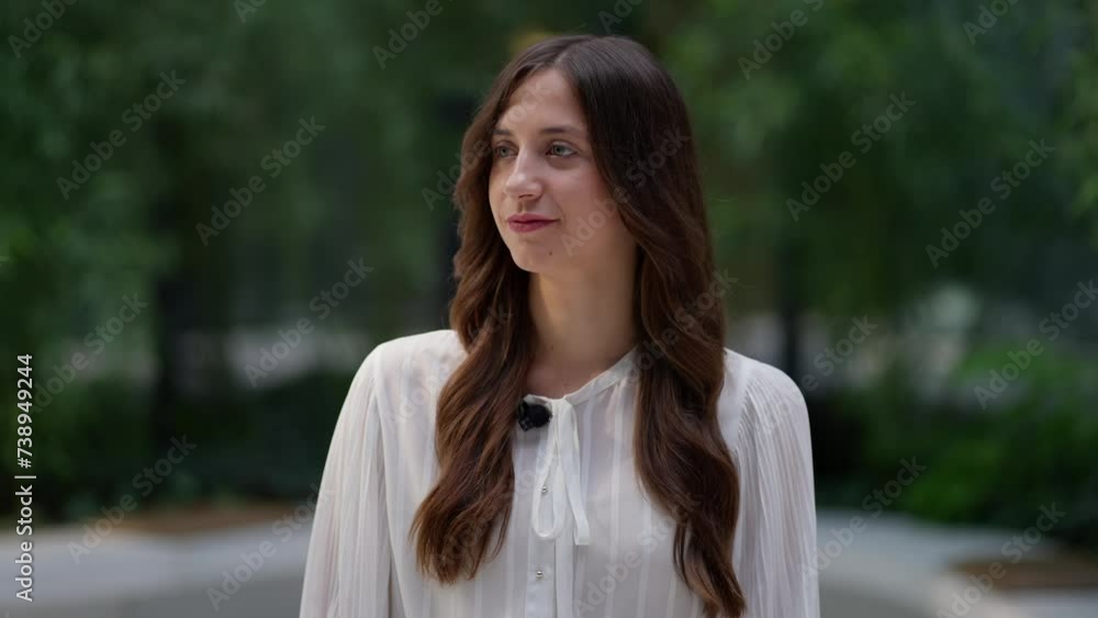 Focused young woman engages in interview, her composed demeanor set against backdrop of lush greenery Concept of Effective Communication Focused young woman engages in interview, her composed demeanor set against backdrop of lush greenery Concept of Effective Communication