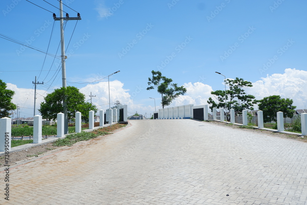 Empty road in the park with blue sky and white cloud background. Empty road in the park with blue sky and white cloud background.