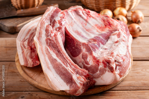 Raw Pork Belly sliced on board with spices. Roasted pork belly