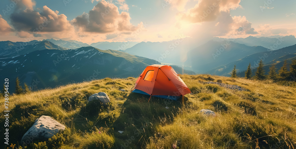 campsite with tent at nature, camping in mountains at sunset