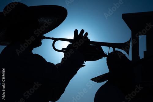 Close up of Mexican Mariachi,  traditional musical ensemble generally made up of a minimum number of three members; generally using guitar, guitar, violin and trumpets