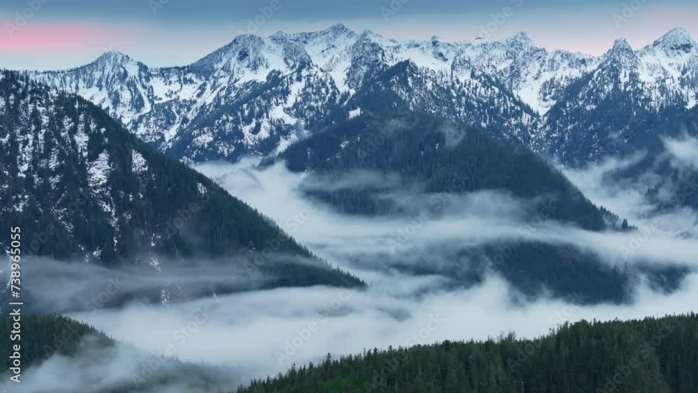 Scenic mist on spruce forest. Clouds drifting in Washington. Cinematic Foggy mountain valley 4K. Fog creeping in North Cascades landscape in twilight. Beautiful winter mountains with evergreen forest Scenic mist on spruce forest. Clouds drifting in Washington. Cinematic Foggy mountain valley 4K. Fog creeping in North Cascades landscape in twilight. Beautiful winter mountains with evergreen forest