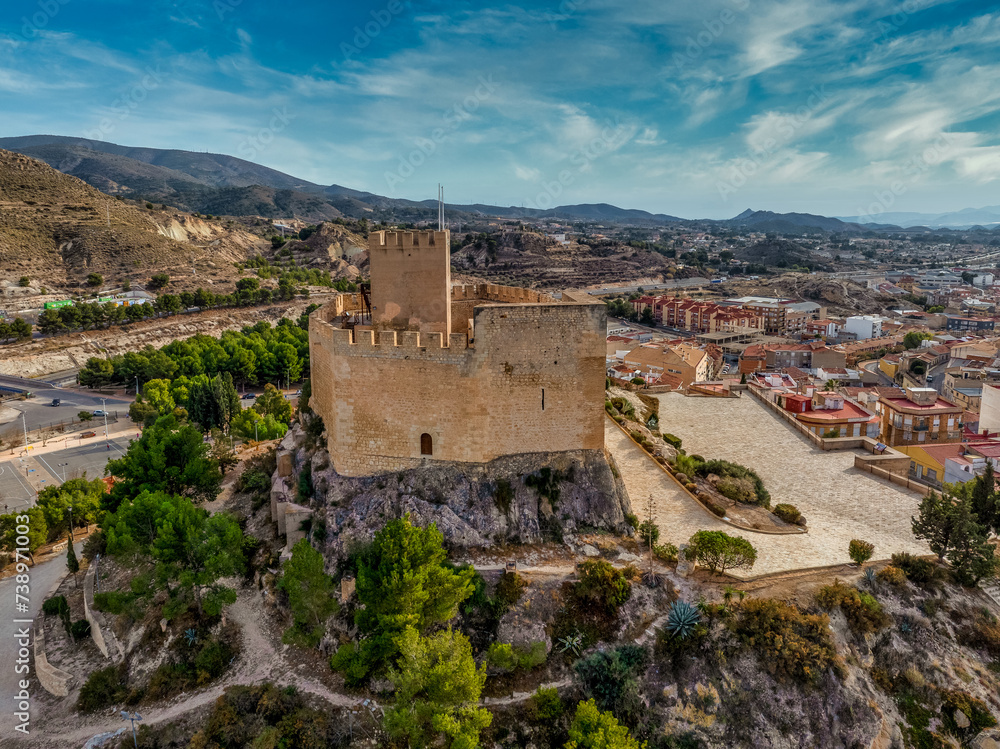 Aerial view of Petrer, medieval town and hilltop castle with restored tower and battlements near Elda Spain,