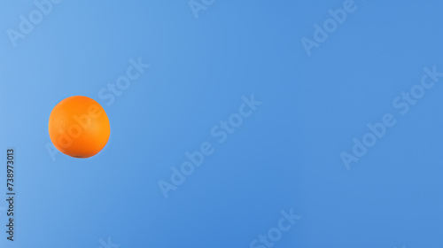 Orange on Sky Blue Background: Minimalist Fruit Concept with Serene Airy Aesthetic
