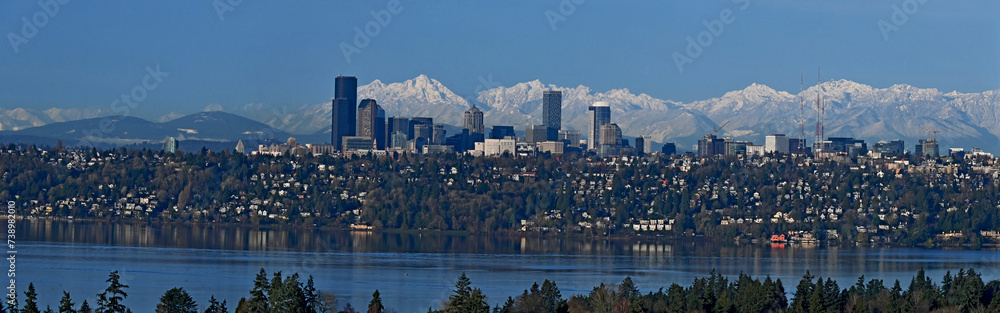 Fototapeta premium Seattle panorama cityscape as seen from the eastside with the Olympic mountains in the background and Lake Washington in the foreground on a beautiful winter day, 20240216_four shot panorama.