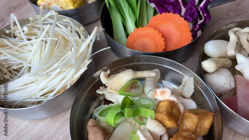 Korean foods served on a dining table. Perfect article, or any cooking contents. traditional hot pot combo, sweet garlic, and beef slices. It is very popular in sichuan photo