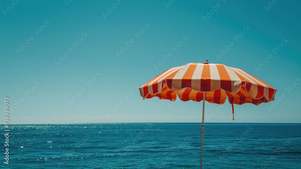Beach umbrella on a sunny day, sea in background Beach umbrella on a sunny day, sea in background
