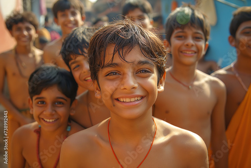 A group of boys on the street in India, smile and laugh to the camera, wide angle close up