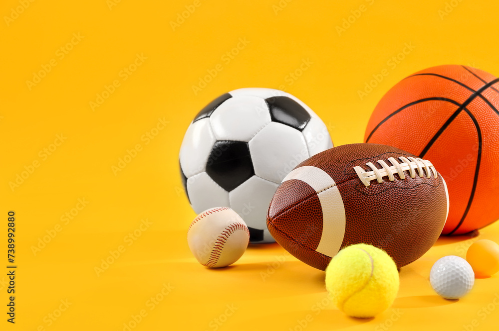 Many different sports balls on yellow background, space for text Many different sports balls on yellow background, space for text