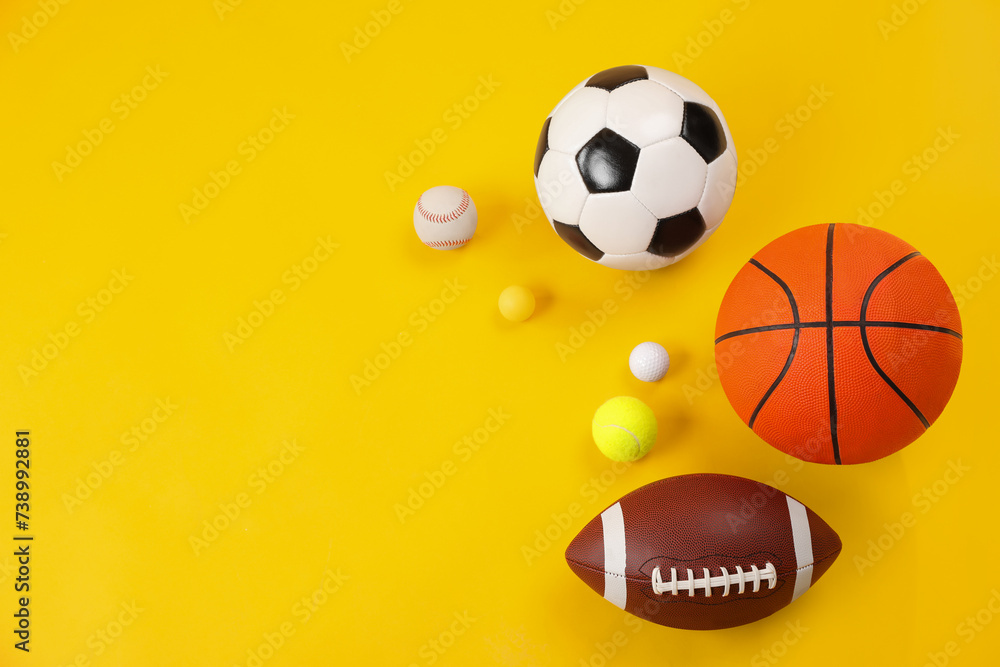 Many different sports balls on yellow background, flat lay. Space for text