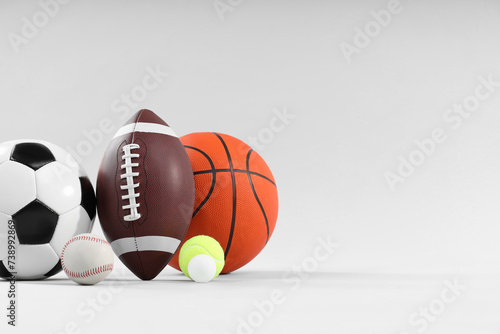Many different sports balls on light gray background  space for text