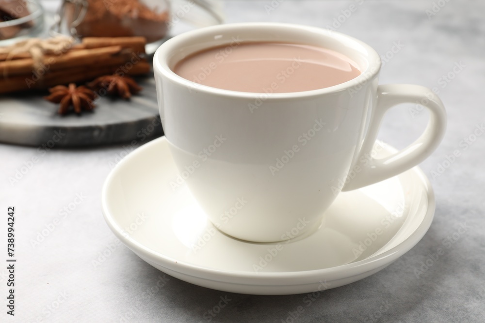 Tasty hot chocolate in cup on grey textured table, closeup Tasty hot chocolate in cup on grey textured table, closeup
