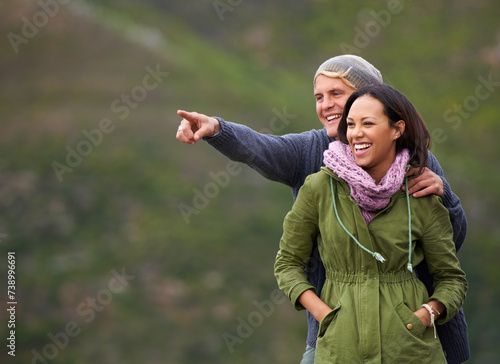 Happy couple, pointing and nature in adventure for sightseeing, journey or outdoor view together. Man and woman with smile enjoying holiday, vacation or getaway in natural environment on mockup