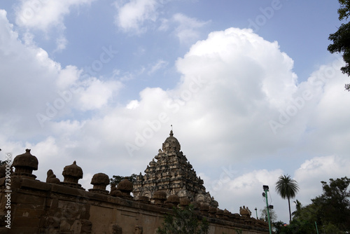 Tower of ancient Kanchi Kailasanathar temple in Kanchipuram, Tamilnadu. Historic Tall Hindu Temple Gopuram against cloudy sky background.