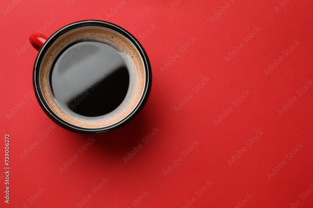 Fresh coffee in cup on red background, top view. Space for text Fresh coffee in cup on red background, top view. Space for text