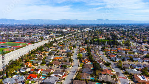 Aerial view of typical single family residential neighborhood in Cupertino, California next to interstate highway 280 photo