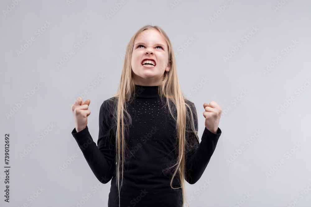 Unwavering determination in child's clenched fists, grit Unwavering determination in child's clenched fists, grit