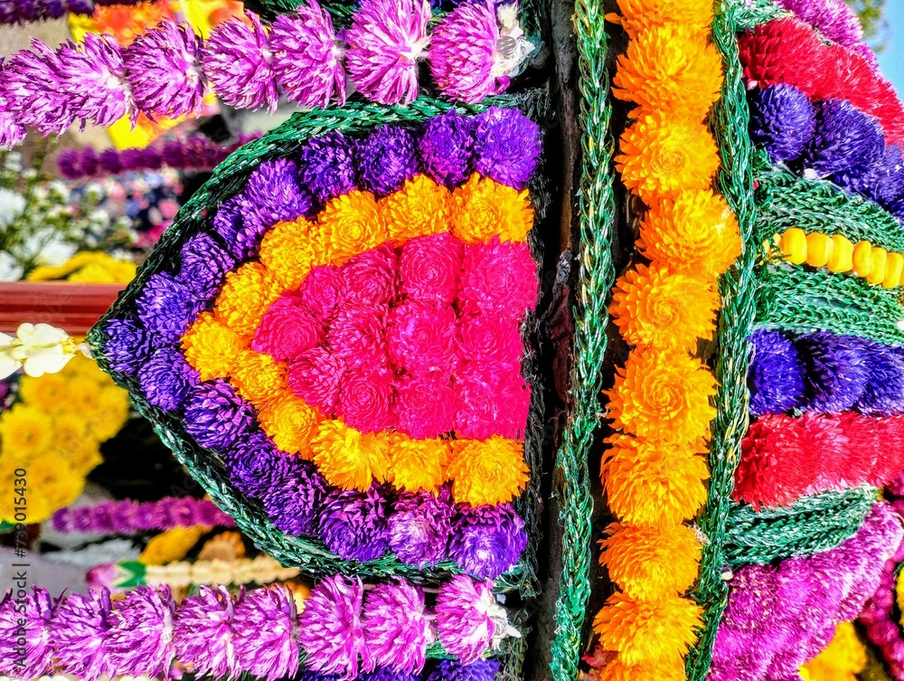 Pictured is the creation of fresh flowers at a winter festival in Thailand. There are multi-colored amaranths and green strings in the decoration.
